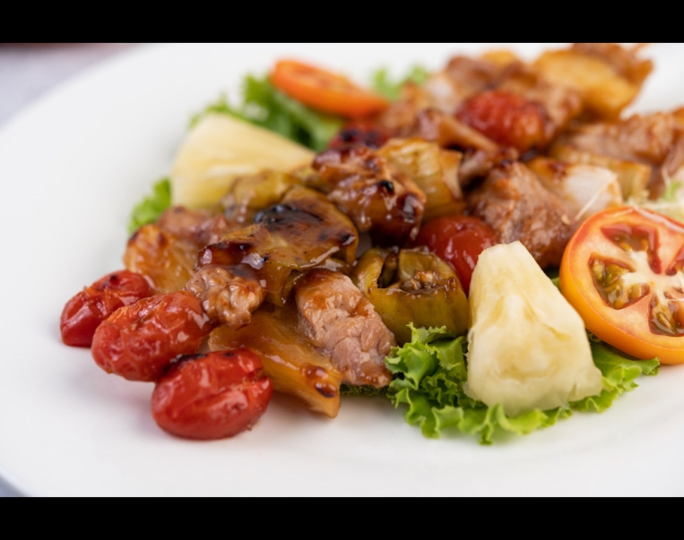 bbq-with-variety-meats-complete-with-tomatoes-bell-peppers-white-plate (1)